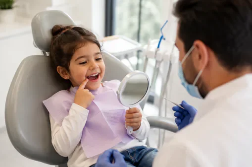 two-years-old-girl-is-learning-brush-her-teeth-with-toothbrush-hand-dental-office young child dental exam